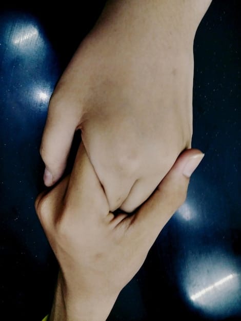 A close-up of two individuals holding hands, emphasizing intimacy and support. The focus is on the hands, symbolizing connection and emotional support, illustrating the importance of emotional connection in addressing The Link Between Mental Health and Sexual Performance: Strategies for Overcoming Anxiety.